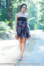 Naked forest justine jewel playfully poses amidst the tall trees on a countryside road, lifting her dress skirt to flash her smooth, pink pussy, in attempt to hitch a ride.