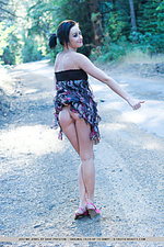 Naked forest justine jewel playfully poses amidst the tall trees on a countryside road, lifting her dress skirt to flash her smooth, pink pussy, in attempt to hitch a ride.