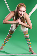 Lovable fun and sweet lapochka looks absolutely stunning in her bright striped stockings and yellow headband, posing playfully in a fishnet hammock.