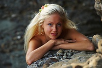 Cave beauty silvia looks like an exotic flower in full bloom as her nubile beauty stands out against the rugged landscape.