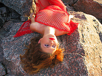 Spring 1 beautifully exotic maria d wears red netting at the beach and lets her large natural tits hang free.