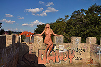 The ruins miniki flaunts her gorgeous body by the brick wall ruins.