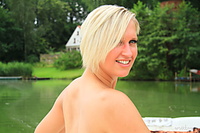 Presenting lusy a lusy a bares her back tattoo and fully nude body as she poses by the river.