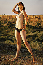 Late afternoon shiny diamond strips outdoors as she displays her tight body and meaty pussy.