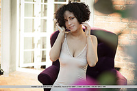 Pammie lee curly-haired pammie lee shows off her big tits and trimmed pussy on the bed.