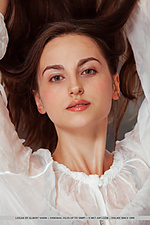 Logan new model logan sensually strips on the bed baring her delectable pussy.