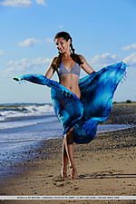 Rosella rosella playfully poses at the beach as she shows off her sexy, tanned body.