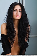 Dark-haired beauty with exotic charms and uninhibited appeal.