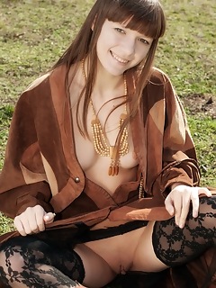 Public nudity red eva displays her slender body in the park.