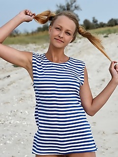 Calli in her striped beach dress and matching pigtails, calli shows off her fun and playful appeal in a beach photo shoot Calli in her striped beach dress and matching pigtails, calli shows off her fun and playful appeal in a beach photo shoot