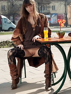Public nudity red eva displays her slender body in the park.